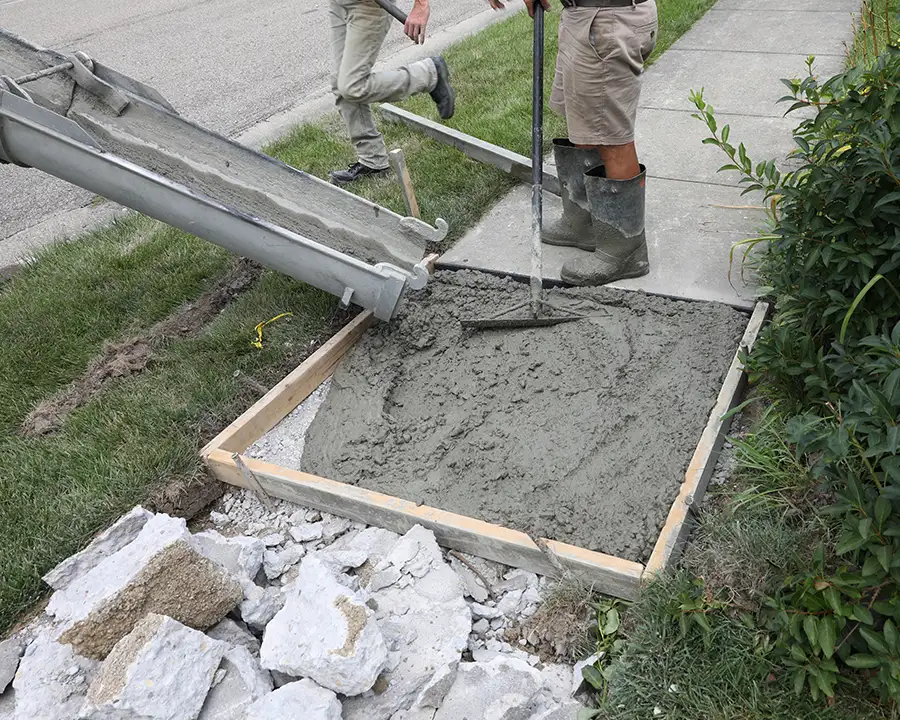 Concrete services, driveways and sidewalks, sidewalk maintenance and repairs, professionals replacing broken concrete slabs on residential sidewalk - Belleville, IL